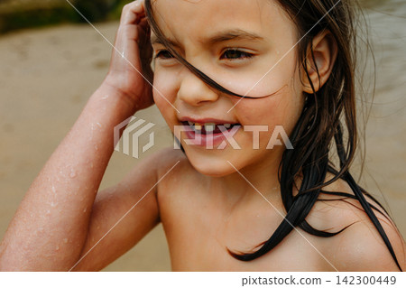 Candid Portrait of Happy Child After Swimming in the Sea Candid Portrait of Happy Child After Swimming in the Sea 142300449