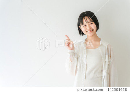 A smiling high school girl points; imagery of college entrance exams and education. 142301658