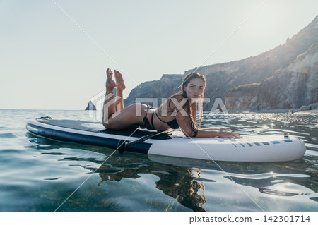 Woman Paddleboard Ocean Coastline Relaxing on Paddleboard 142301714