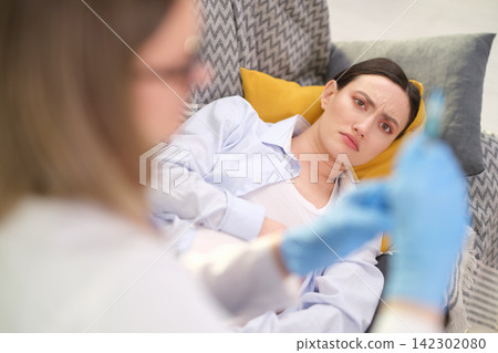 Competent physician prepares appropriate medication in syringe Competent physician prepares appropriate medication in syringe 142302080