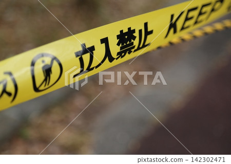 A close-up photograph of yellow caution tape with the words "No Entry" printed on it. A close-up photograph of yellow caution tape with the words "No Entry" printed on it. 142302471