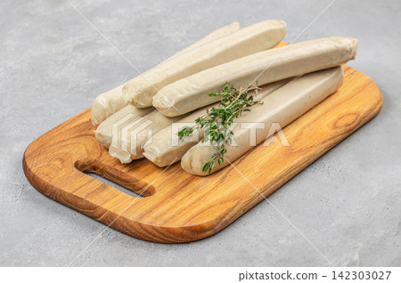 Raw White Sausages with Thyme on Wooden Board Raw White Sausages with Thyme on Wooden Board 142303027