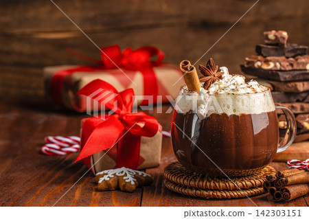 Christmas Hot Chocolate with Gifts and Cinnamon Christmas Hot Chocolate with Gifts and Cinnamon 142303151