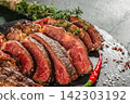 Medium rare sliced tomahawk steak with chili pepper and sea salt close up 142303192