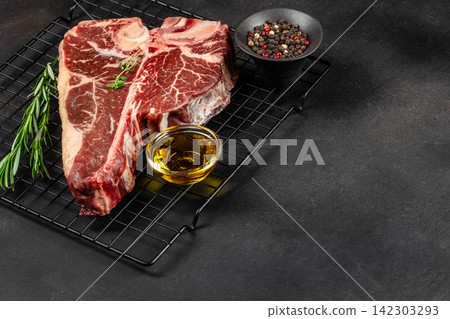 Raw Tomahawk Steak with Peppercorns and Oil Raw Tomahawk Steak with Peppercorns and Oil 142303293