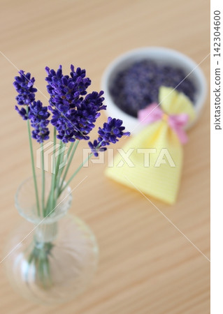 A life with lavender in a vase and a handmade sachet. A life with lavender in a vase and a handmade sachet. 142304600