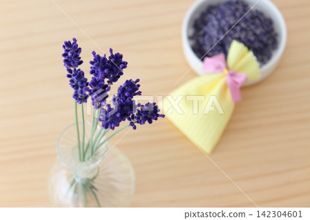 A life with lavender in a vase and a handmade sachet. A life with lavender in a vase and a handmade sachet. 142304601