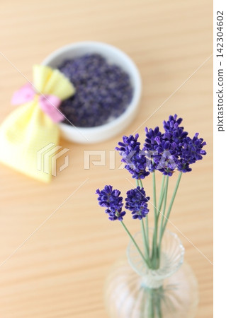 A life with lavender in a vase and a handmade sachet. A life with lavender in a vase and a handmade sachet. 142304602