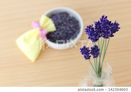 A life with lavender in a vase and a handmade sachet. A life with lavender in a vase and a handmade sachet. 142304603