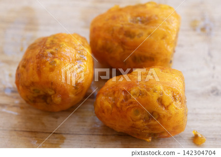 peeled prickly pears on wooden background 142304704