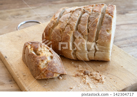 Sliced sourdough bread on cutting board Sliced sourdough bread on cutting board 142304717