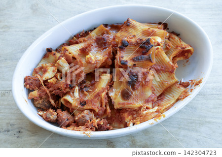 Baked pasta dish with cheese tomato sauce Baked pasta dish with cheese tomato sauce 142304723