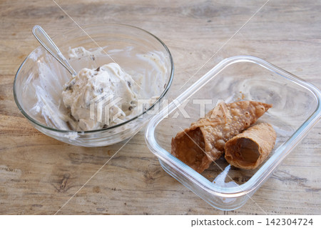 Sicilian cannoli cream preparation on wood Sicilian cannoli cream preparation on wood 142304724