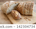 Sliced sourdough bread on cutting board 142304734