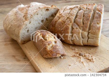 Sliced sourdough bread on cutting board Sliced sourdough bread on cutting board 142304734