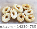 Fried squid rings in plastic container 142304735