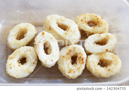 Fried squid rings in plastic container Fried squid rings in plastic container 142304735