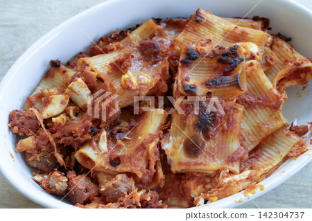 Baked pasta dish with cheese tomato sauce Baked pasta dish with cheese tomato sauce 142304737
