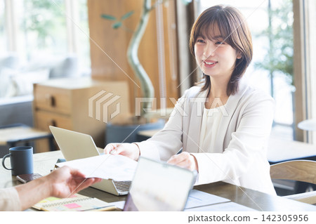Business woman watching materials Business woman watching materials 142305956