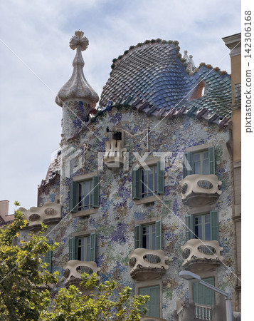 Exterior view of Casa Batllo by Antoni Gaudi in Barcelona Spain showing its colorful modernist facade and distinctive architectural details Exterior view of Casa Batllo by Antoni Gaudi in Barcelona Spain showing its colorful modernist facade and distinctive architectural details 142306168