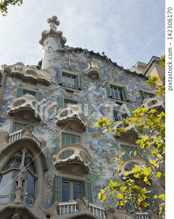 Exterior view of Casa Batllo by Antoni Gaudi in Barcelona Spain showing its colorful modernist facade and distinctive architectural details Exterior view of Casa Batllo by Antoni Gaudi in Barcelona Spain showing its colorful modernist facade and distinctive architectural details 142306170
