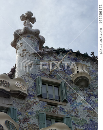 Exterior view of Casa Batllo by Antoni Gaudi in Barcelona Spain showing its colorful modernist facade and distinctive architectural details 142306171