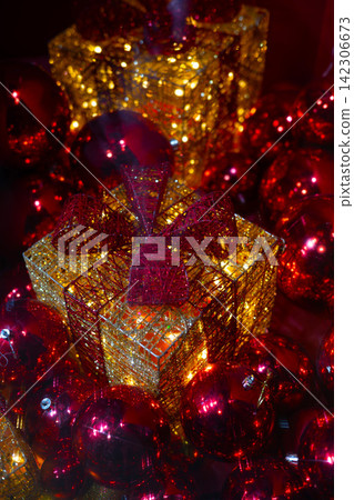 Luxury Christmas Gift Box with Red Ornaments and Glitter Decoration. Luxury Christmas Gift Box with Red Ornaments and Glitter Decoration. 142306673