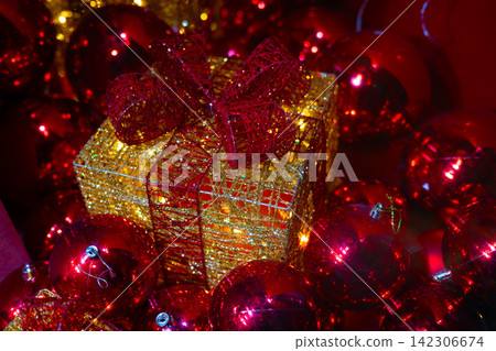 Luxury Christmas Gift Box with Red Ornaments and Glitter Decoration. Luxury Christmas Gift Box with Red Ornaments and Glitter Decoration. 142306674