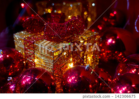 Luxury Christmas Gift Box with Red Ornaments and Glitter Decoration. Luxury Christmas Gift Box with Red Ornaments and Glitter Decoration. 142306675