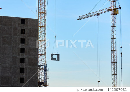 Crane hooks and steel cables against clear blue sky 142307081