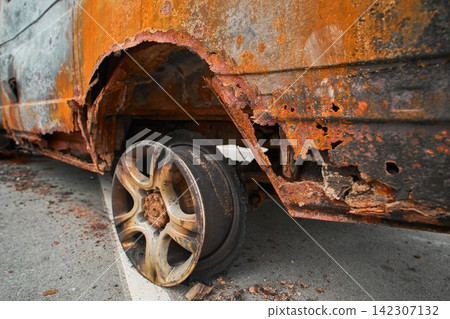 Melted Exploded Car Tire and Charred Wheel Rim Detail Melted Exploded Car Tire and Charred Wheel Rim Detail 142307132