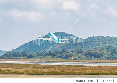 A large passenger plane shortly after takeoff A large passenger plane shortly after takeoff 142307271