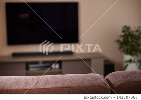 Living room sofa with blurred modern tv setup Living room sofa with blurred modern tv setup 142307363