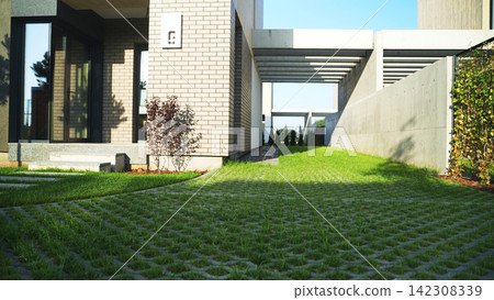 Modern house entrance with concrete and brick facade, pathway leading to contemporary residential building exterior Modern house entrance with concrete and brick facade, pathway leading to contemporary residential building exterior 142308339