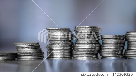 A stack of coins stacked on each other in different positions. Money A stack of coins stacked on each other in different positions. Money 142309320
