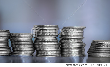 A stack of coins stacked on each other in different positions. Money A stack of coins stacked on each other in different positions. Money 142309321