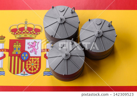 Liquefied gas storage tanks set against the Spanish flag, as a background for your design 142309523