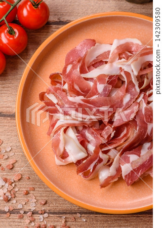 Slices of pork pancetta, ham, or bacon for a festive antipasto platter Slices of pork pancetta, ham, or bacon for a festive antipasto platter 142309580