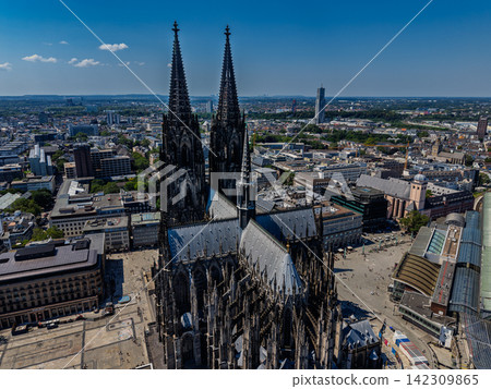 High angle wide horizontal aerial drone photograph of Cologne Cathedral spires, gothic nave, Roncalliplatz square, and city skyline in Cologne, North Rhine-Westphalia, Germany on sunny summer day High angle wide horizontal aerial drone photograph of Cologne Cathedral spires, gothic nave, Roncalliplatz square, and city skyline in Cologne, North Rhine-Westphalia, Germany on sunny summer day 142309865