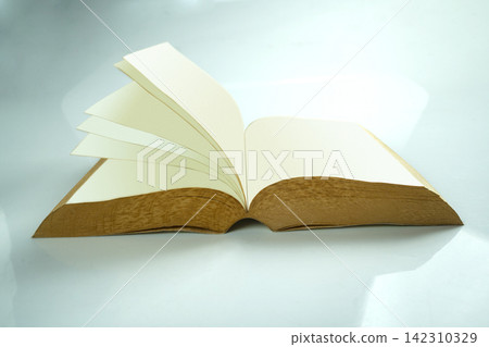 An open book with blank white pages and textured brown edges, with one page flipping over, set against a clean, light gradient background. Study or education concept An open book with blank white pages and textured brown edges, with one page flipping over, set against a clean, light gradient background. Study or education concept 142310329