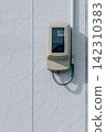 Outdoor electric meter installed on the exterior wall of a house 142310383