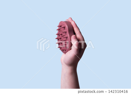 Hair and scalp massager. Device for hair care and treatment. Image for topic about hair growth and beauty salon. Copy space Hair and scalp massager. Device for hair care and treatment. Image for topic about hair growth and beauty salon. Copy space 142310416