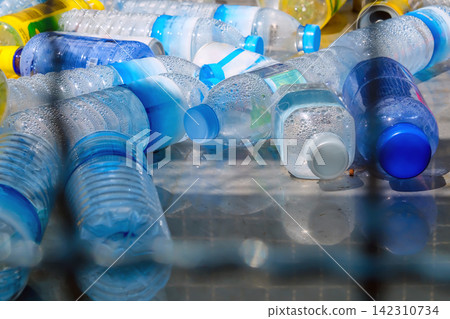 Plastic bottles and containers prepared for recycling Plastic bottles and containers prepared for recycling 142310734