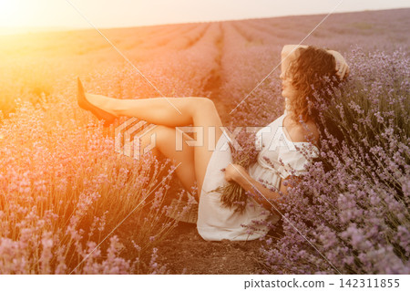 Lavender field woman sitting summer flowering plant wearing white dress relaxing in sunset sunlight during warm golden hour Lavender field woman sitting summer flowering plant wearing white dress relaxing in sunset sunlight during warm golden hour 142311855