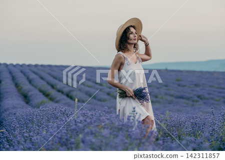Lavender field woman straw hat posing in rural landscape during sunset representing summer vacations and nature connection with copy space Lavender field woman straw hat posing in rural landscape during sunset representing summer vacations and nature connection with copy space 142311857
