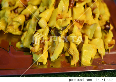 Yellow mushroom dish served on red plate with rustic texture and warm color 142312008