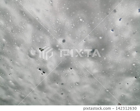 The windshield of a car being washed with foam in an automatic car wash. The windshield of a car being washed with foam in an automatic car wash. 142312630