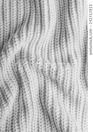 White knitted fabric texture with folds, wrinkles and soft waves, crumpled wool background White knitted fabric texture with folds, wrinkles and soft waves, crumpled wool background 142312913