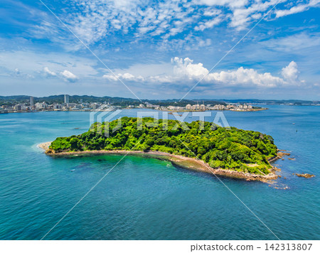 A panoramic view of Sarushima, an uninhabited island, taken from 145 meters above Yokosuka City on a clear summer morning, with the city of Yokosuka in the background. A panoramic view of Sarushima, an uninhabited island, taken from 145 meters above Yokosuka City on a clear summer morning, with the city of Yokosuka in the background. 142313807