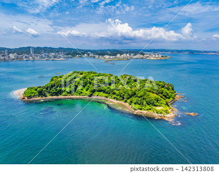 A panoramic view of Sarushima, an uninhabited island, taken from 145 meters above Yokosuka City on a clear summer morning, with the city of Yokosuka in the background. A panoramic view of Sarushima, an uninhabited island, taken from 145 meters above Yokosuka City on a clear summer morning, with the city of Yokosuka in the background. 142313808